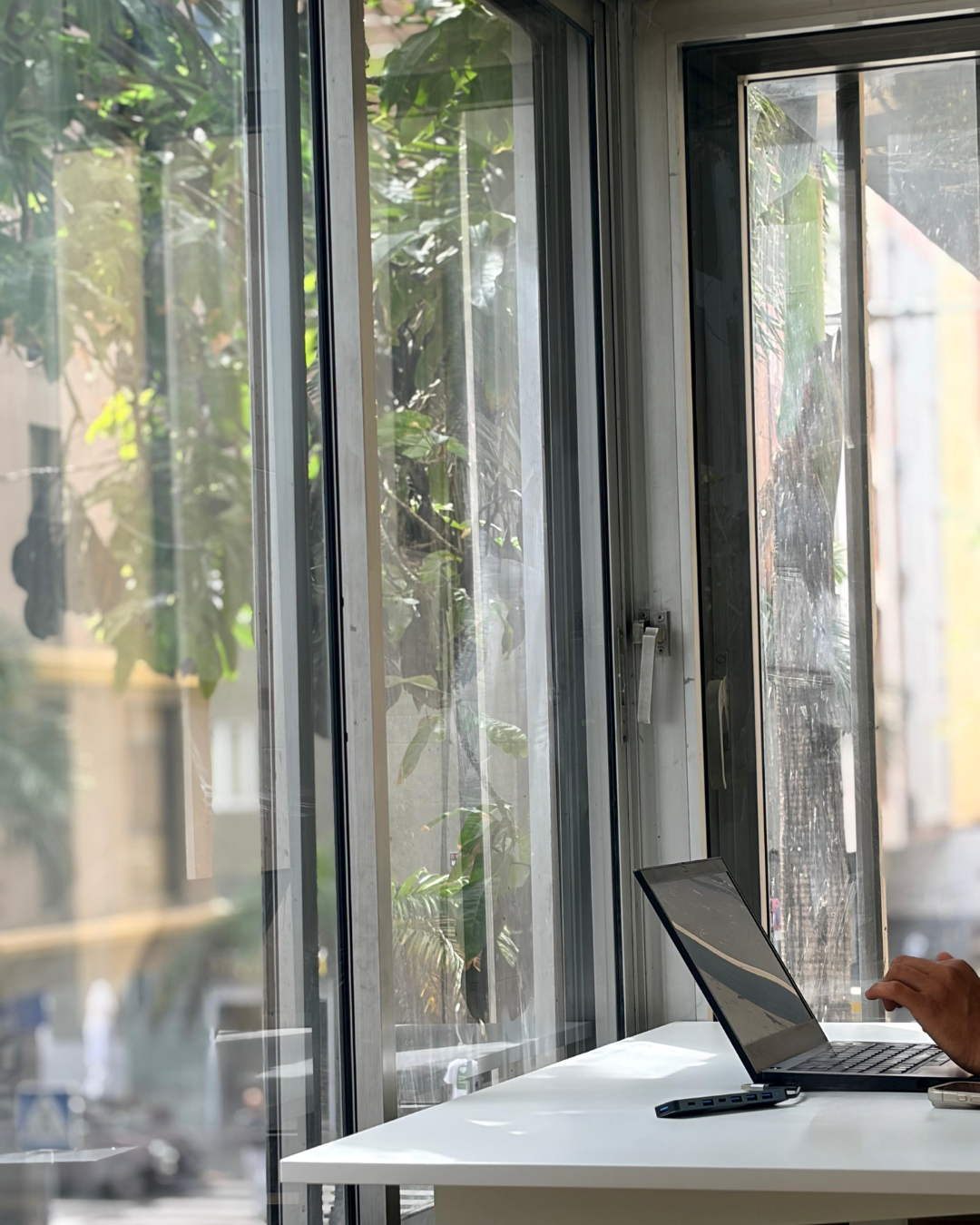 Home Standing desk by a glass window at Nas Coworking in Las Palmas